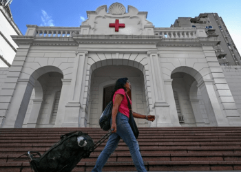 Una mujer pasa frente a la sede principal De la Cruz Roja en Caracas, Venezuela, este sábado 5 de agosto de 2023. Este lunes, se revelaron los nuevos directivos de la junta interventora de la organización, tras decisión judicial.