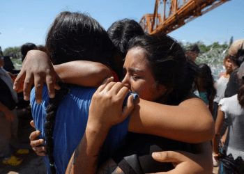 Foto de archivo. Migrantes venezolanos se abrazan después de cruzar el Río Grande y pasar a través del alambre de púas en Eagle Pass, Texas, el 28 de septiembre de 2023. REUTERS/Brian Snyder
